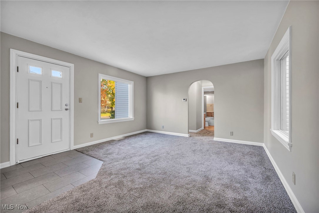 503 Churchill Road Youngstown, OH 44505 - Photo 2 of 32 Foyer entrance with arched walkways, carpet floors, and tile patterned flooring