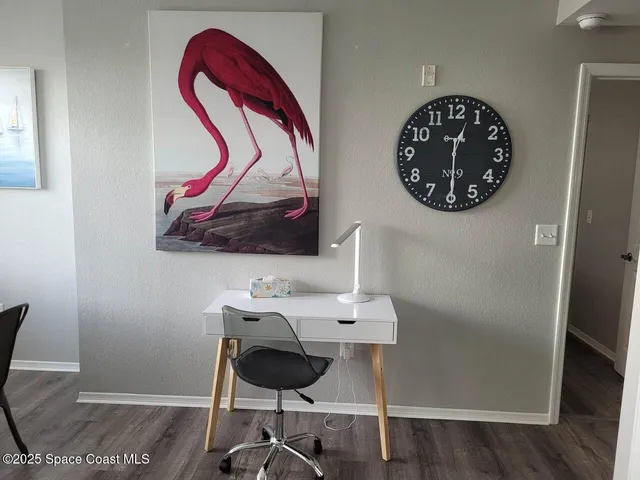 a workspace with wooden floor and a table