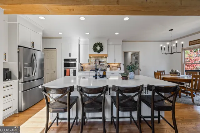 a utility room with cabinets washer and dryer