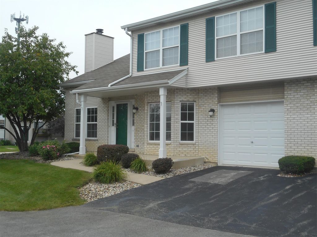 1456 Berta Drive Crest Hill, IL 60403 - Photo 2 of 17 a front view of a house with a yard and garage