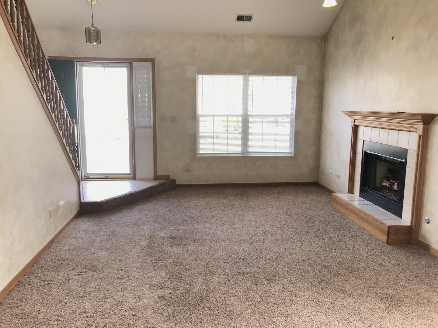 1456 Berta Drive Crest Hill, IL 60403 - Photo 4 of 17 an empty room with windows and fireplace