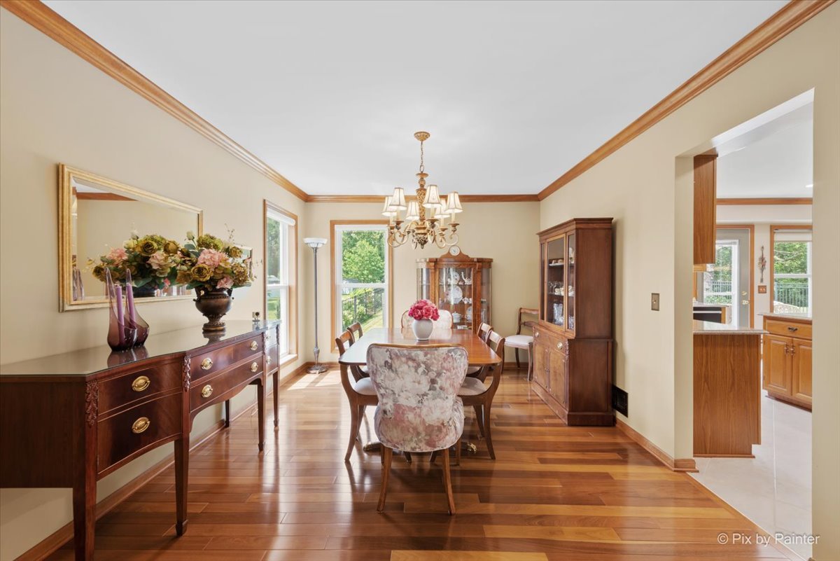 936 Ridgewood Drive Cary, IL 60013 - Photo 8 of 45 a view of a dining room with furniture and wooden floor