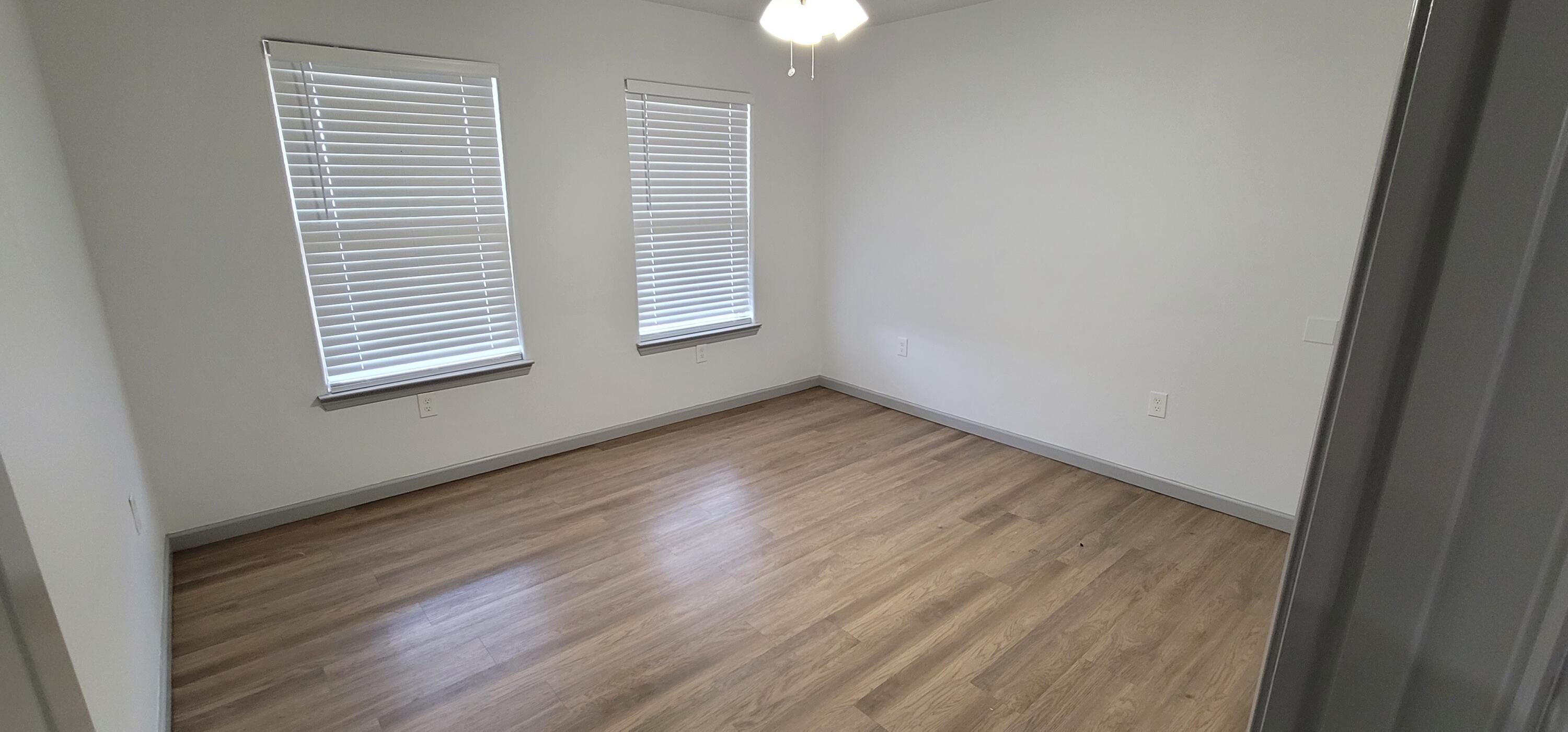 2110 88th Street Lubbock, TX 79423 - Photo 15 of 22 wooden floor in an empty room with a window