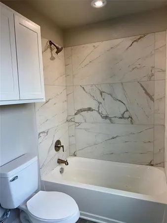 a bathroom with a toilet and a bathtub