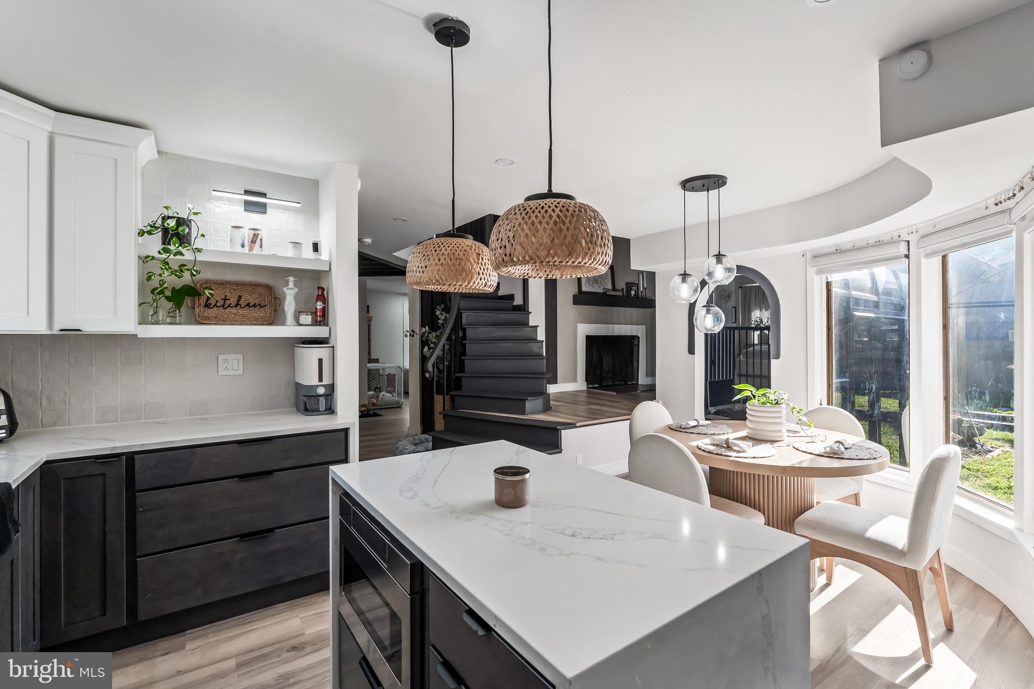 3300 Springfield Avenue Pennsauken, NJ 08109 - Photo 32 of 56 a view of a dining room and livingroom with furniture wooden floor a chandelier