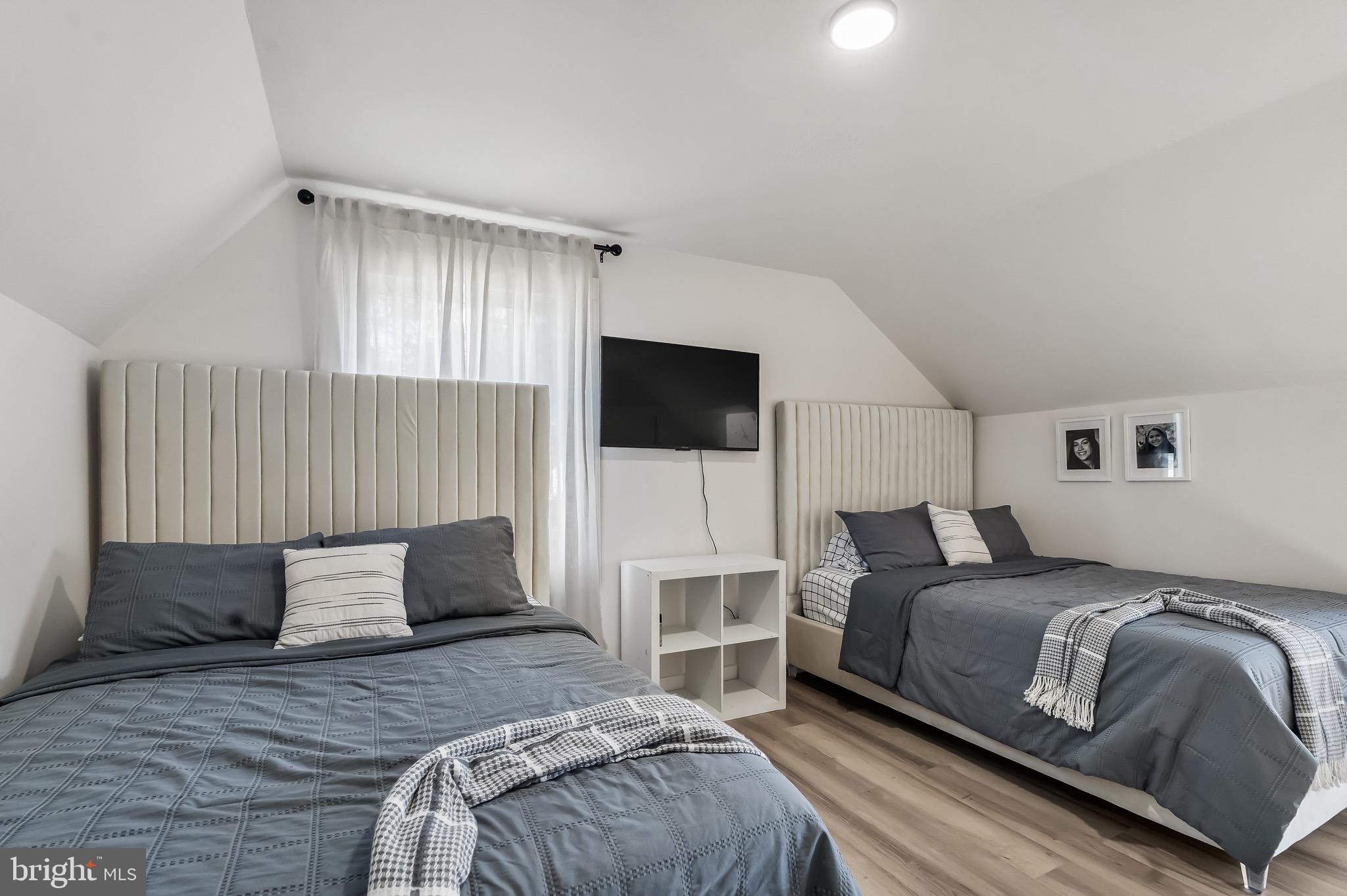 3300 Springfield Avenue Pennsauken, NJ 08109 - Photo 36 of 56 a bedroom with a bed flat screen tv and a couch