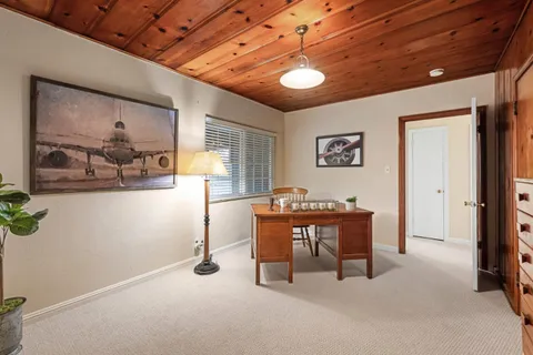 a kitchen with stainless steel appliances a table chairs and a refrigerator