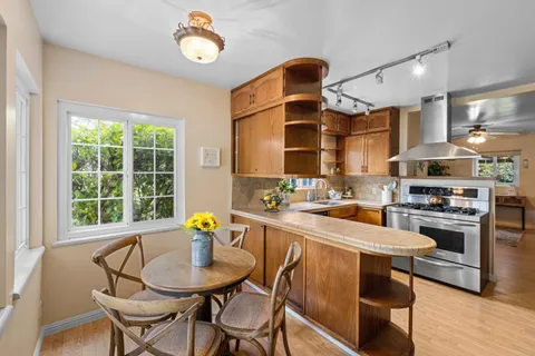 a kitchen with stainless steel appliances a stove a sink and a cabinets