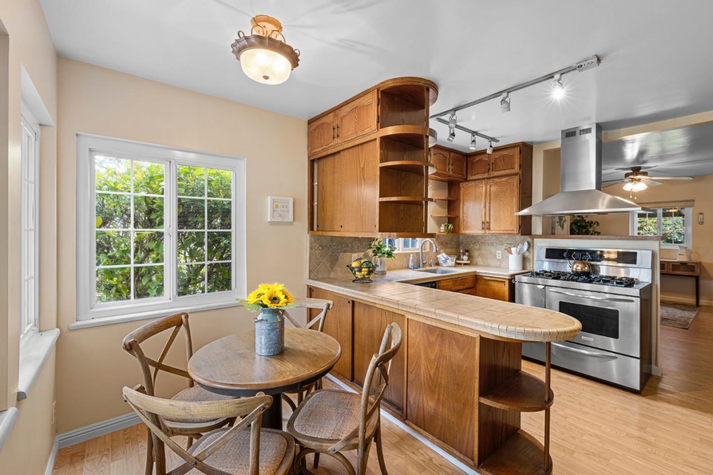 13755 Columbet Avenue San Martin, CA 95046 - Photo 19 of 61 a kitchen with stainless steel appliances a table chairs and a refrigerator