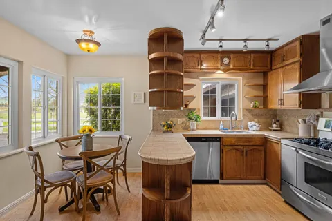 a kitchen with a sink stove and wooden cabinets