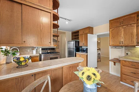 a kitchen with stainless steel appliances a stove a sink and a refrigerator