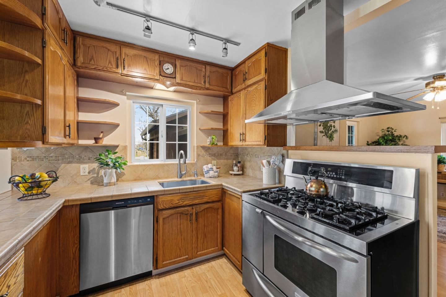 13755 Columbet Avenue San Martin, CA 95046 - Photo 22 of 61 a kitchen with stainless steel appliances a stove a sink and a cabinets