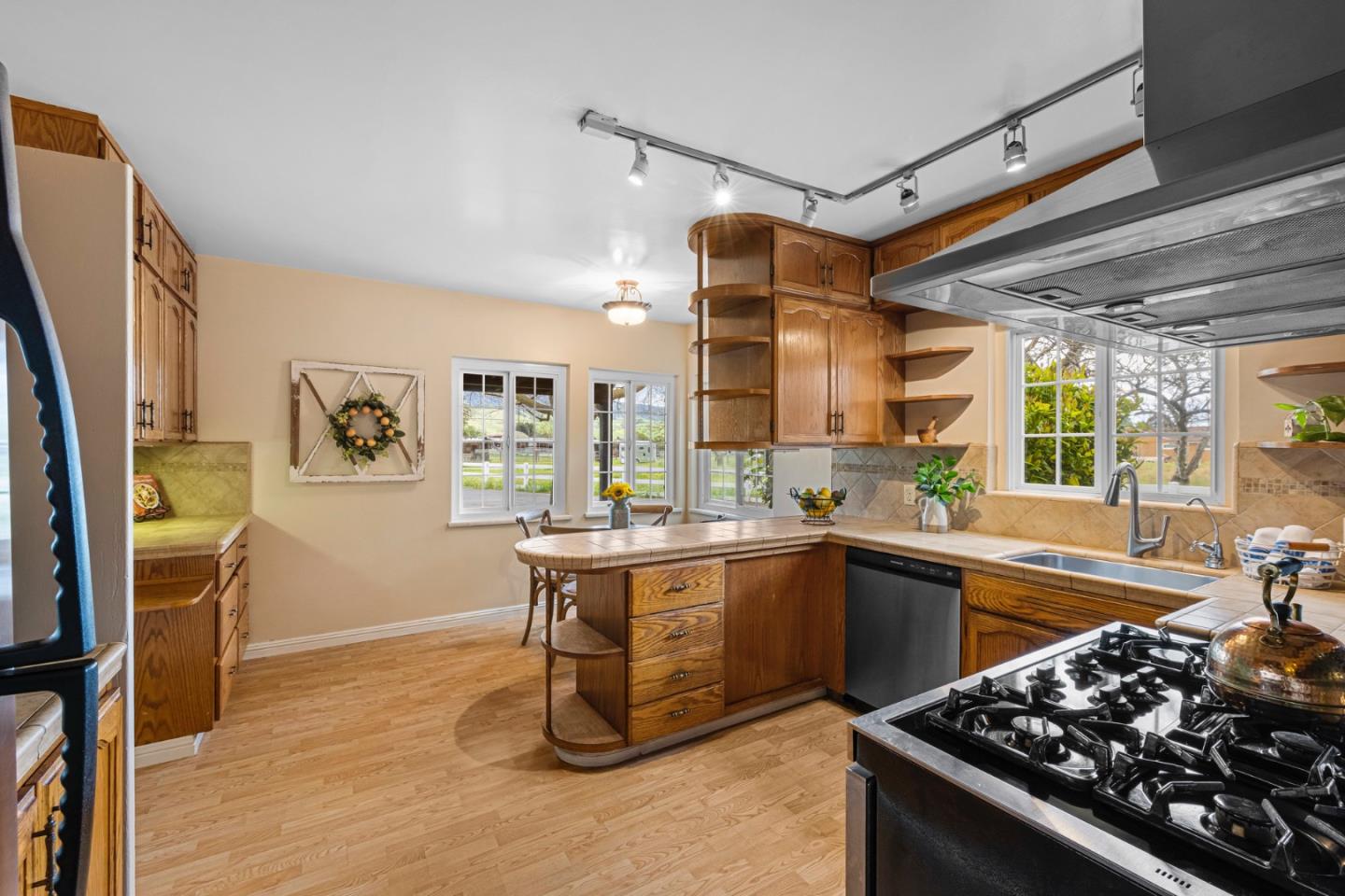 13755 Columbet Avenue San Martin, CA 95046 - Photo 23 of 61 a kitchen with a sink stove and wooden cabinets
