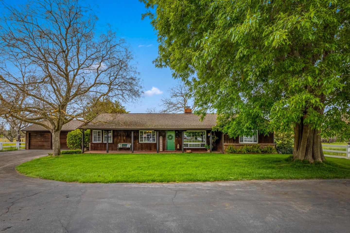 13755 Columbet Avenue San Martin, CA 95046 - Photo 3 of 61 a view of a white house that has a tree in front of it