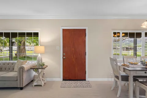 a living room with furniture a fireplace and a window