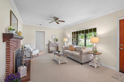 a view of a livingroom with workspace and a window