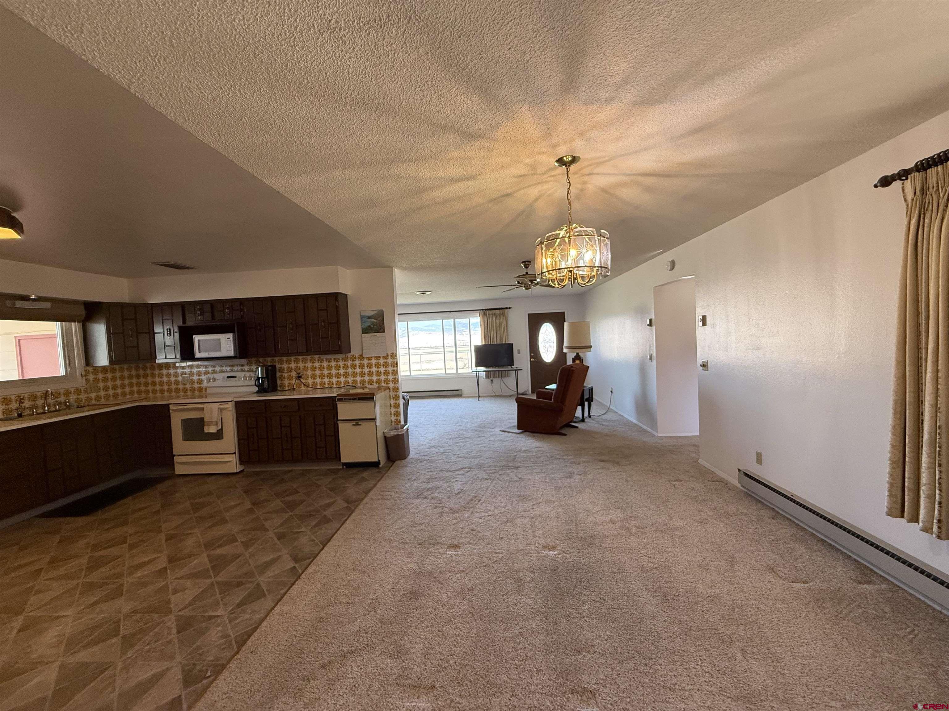 1793 Roundup Road Delta, CO 81416 - Photo 24 of 41 a large kitchen with a refrigerator and a stove top oven