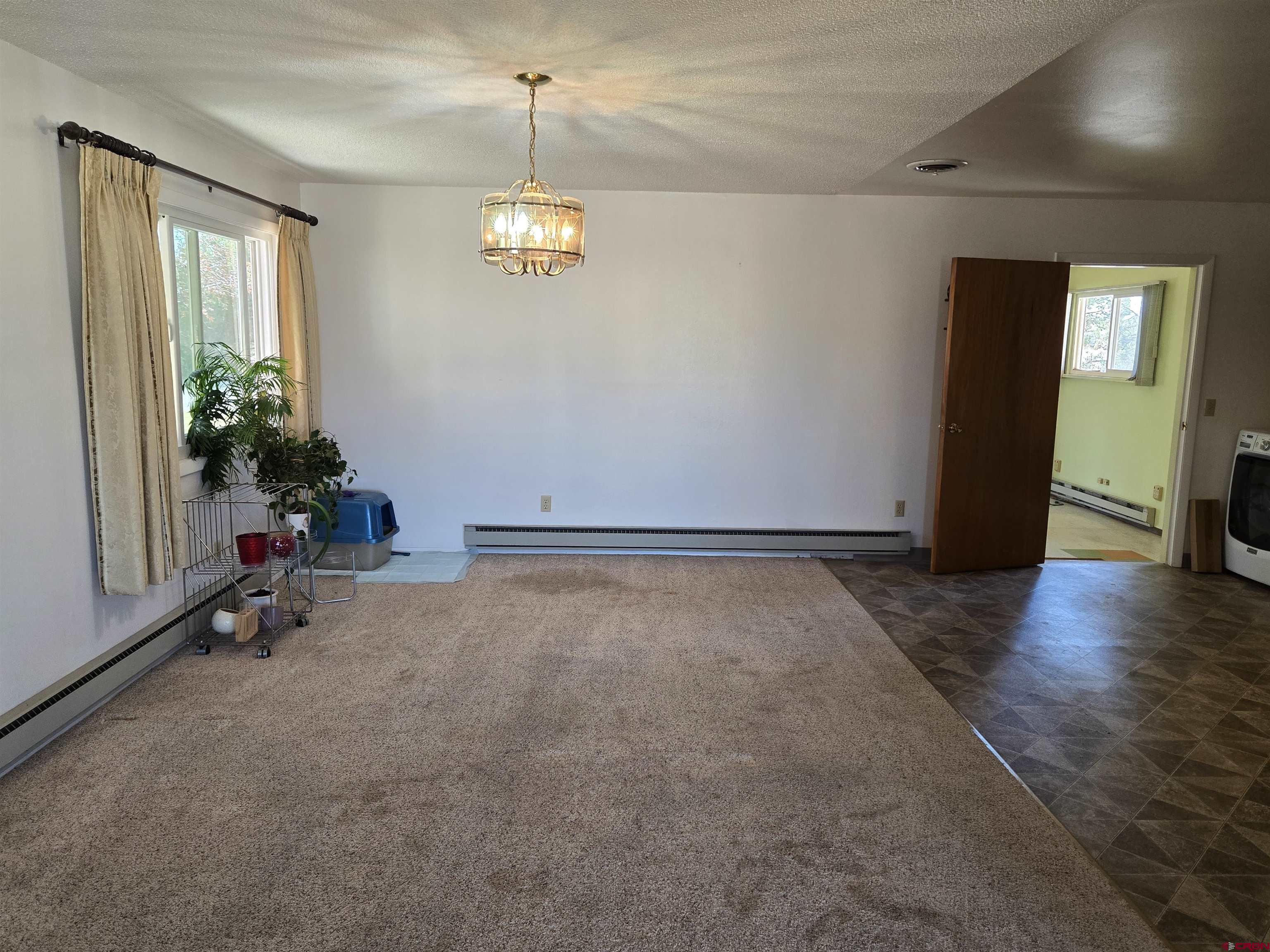 1793 Roundup Road Delta, CO 81416 - Photo 28 of 41 a view of empty room with a window and wooden floor