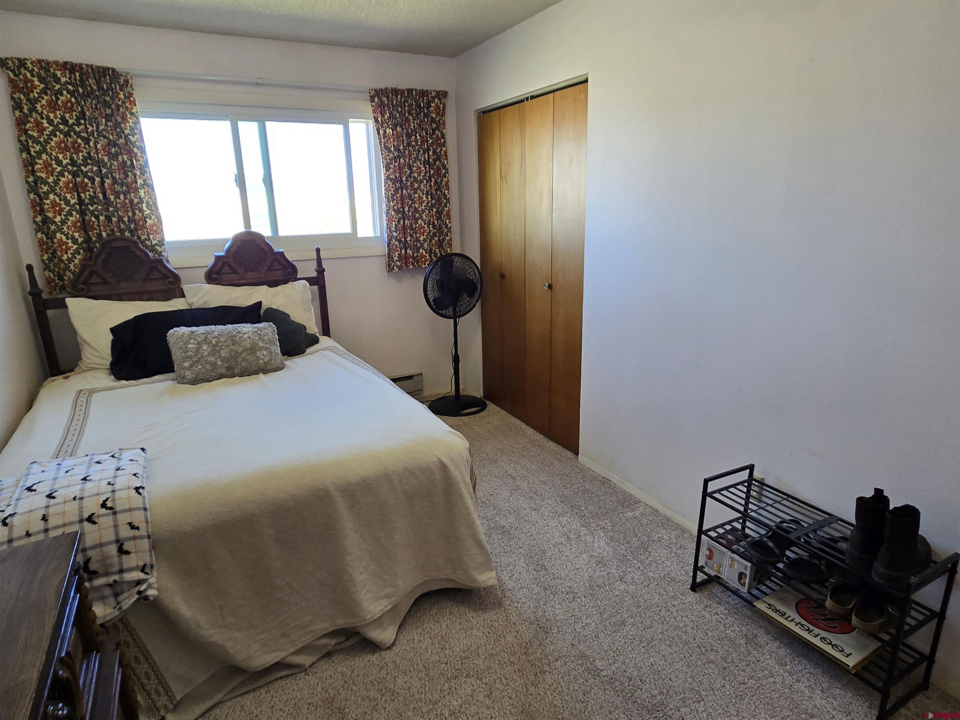 1793 Roundup Road Delta, CO 81416 - Photo 32 of 41 a bedroom with a bed and a window