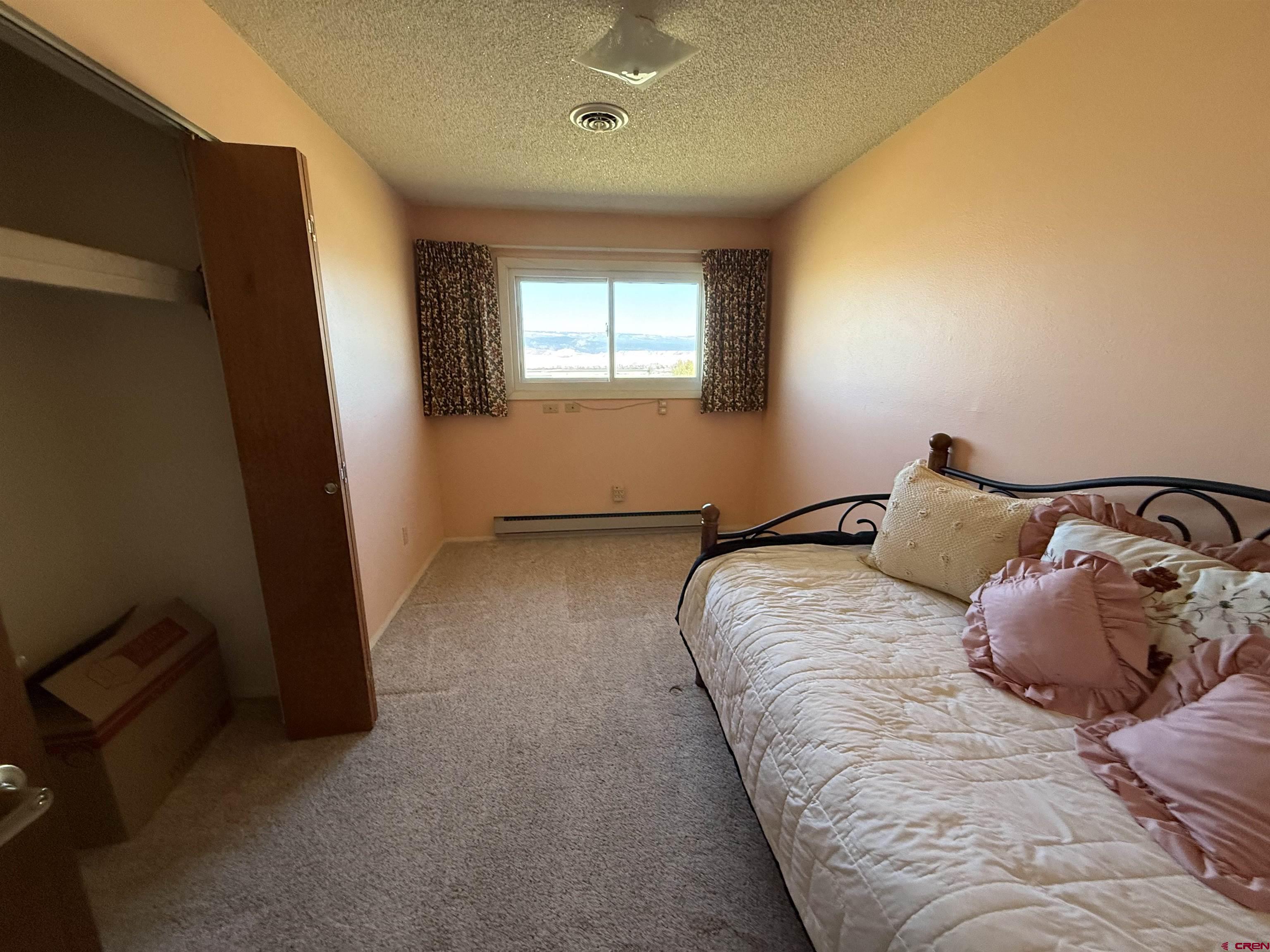 1793 Roundup Road Delta, CO 81416 - Photo 33 of 41 a bedroom with bed and window