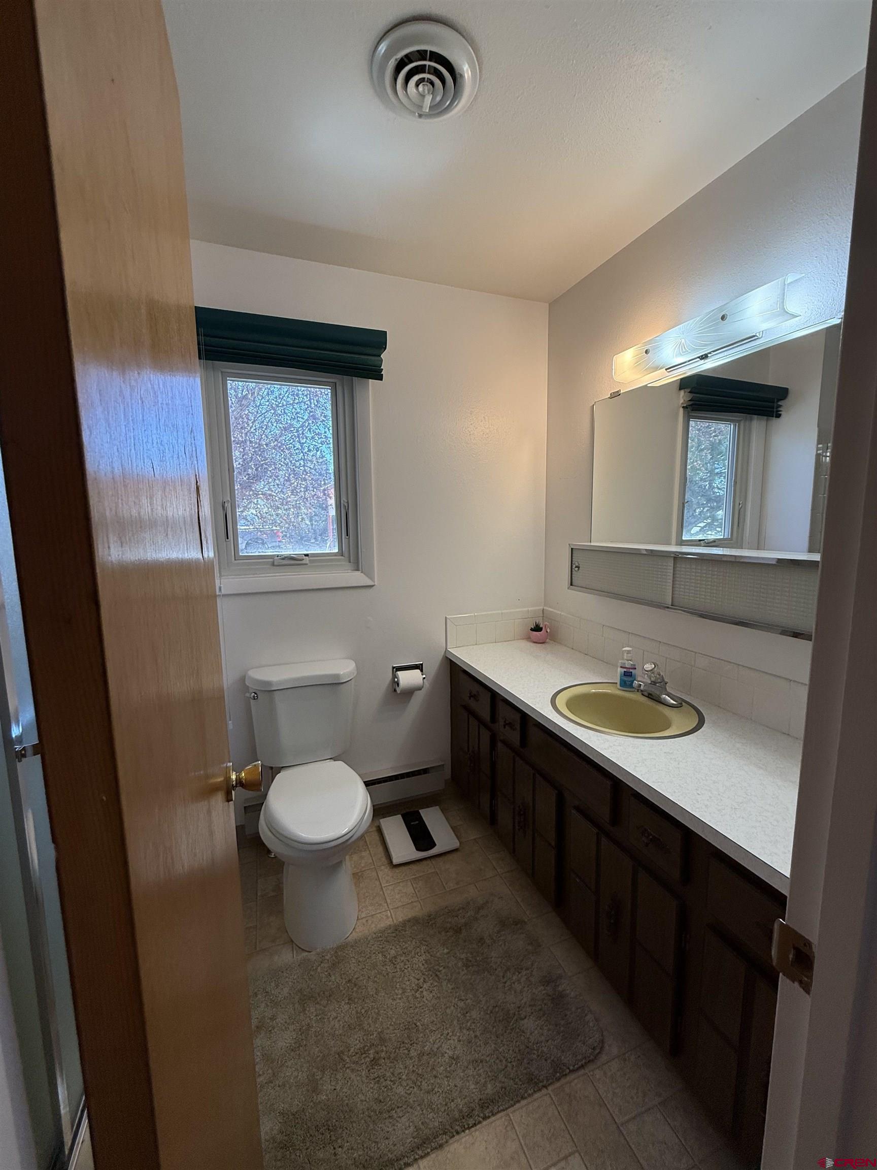 1793 Roundup Road Delta, CO 81416 - Photo 34 of 41 a bathroom with a toilet sink double vanity and mirror