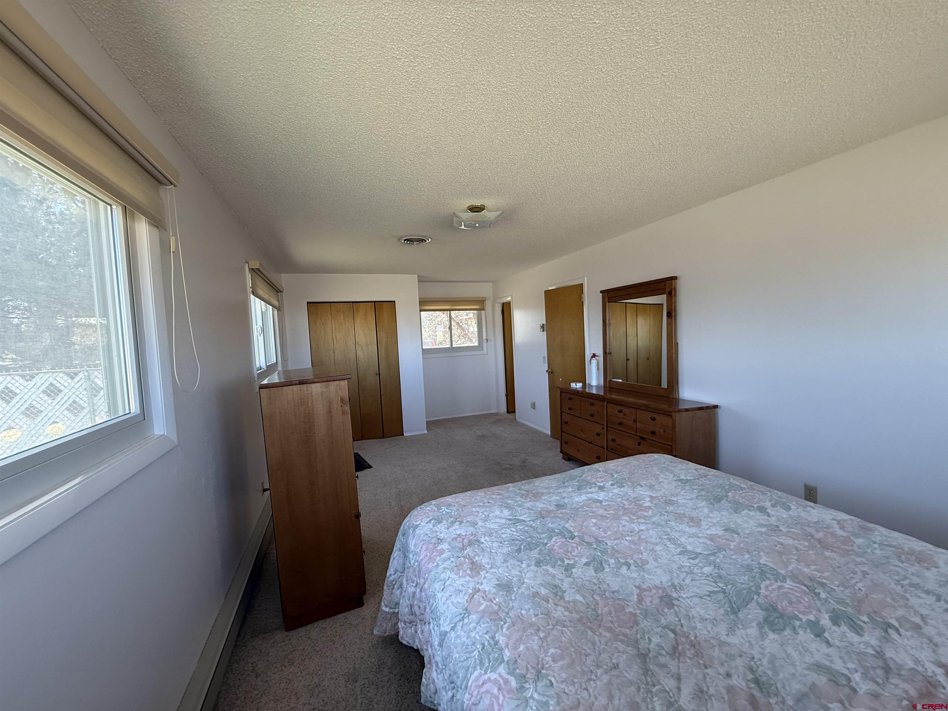 1793 Roundup Road Delta, CO 81416 - Photo 37 of 41 a bedroom with a large bed and a window
