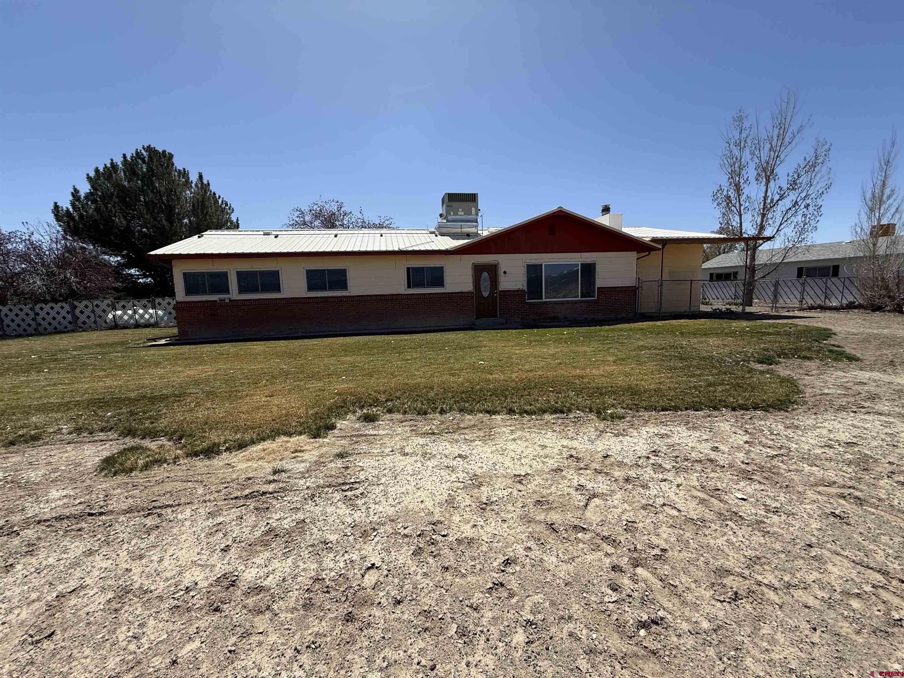 1793 Roundup Road Delta, CO 81416 - Photo 9 of 41 a front view of a house with a yard