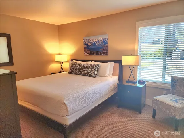 a bedroom with a bed and a night stand