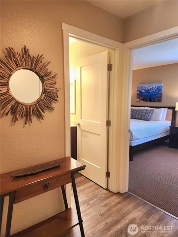 a view of a room with wooden floor and furniture