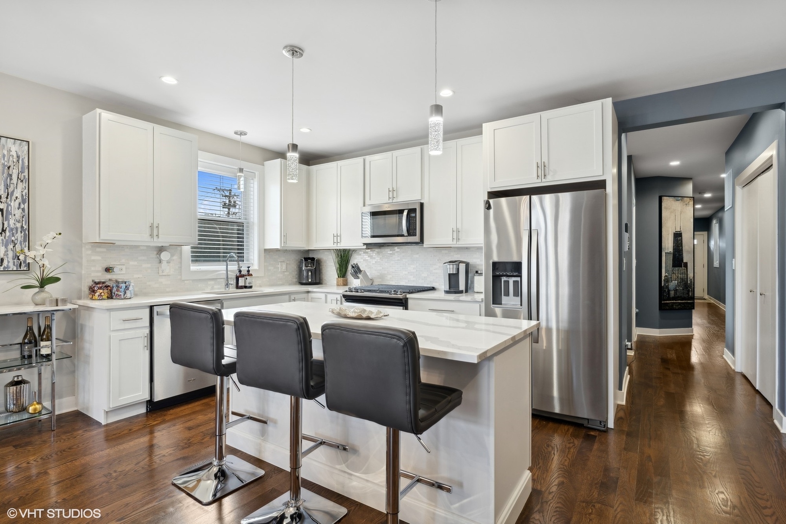 1449 East 65th Place, Unit 1 Chicago, IL 60637 - Photo 5 of 18 a kitchen with stainless steel appliances granite countertop a refrigerator a stove a sink dishwasher and a refrigerator with wooden floor