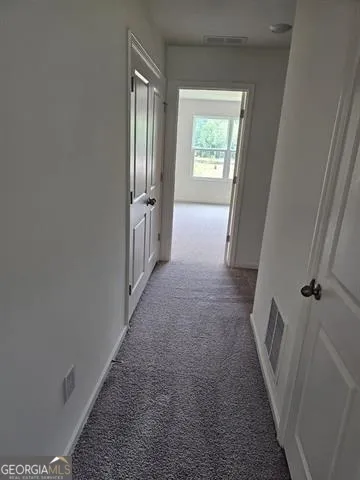 a view of hallway with windows