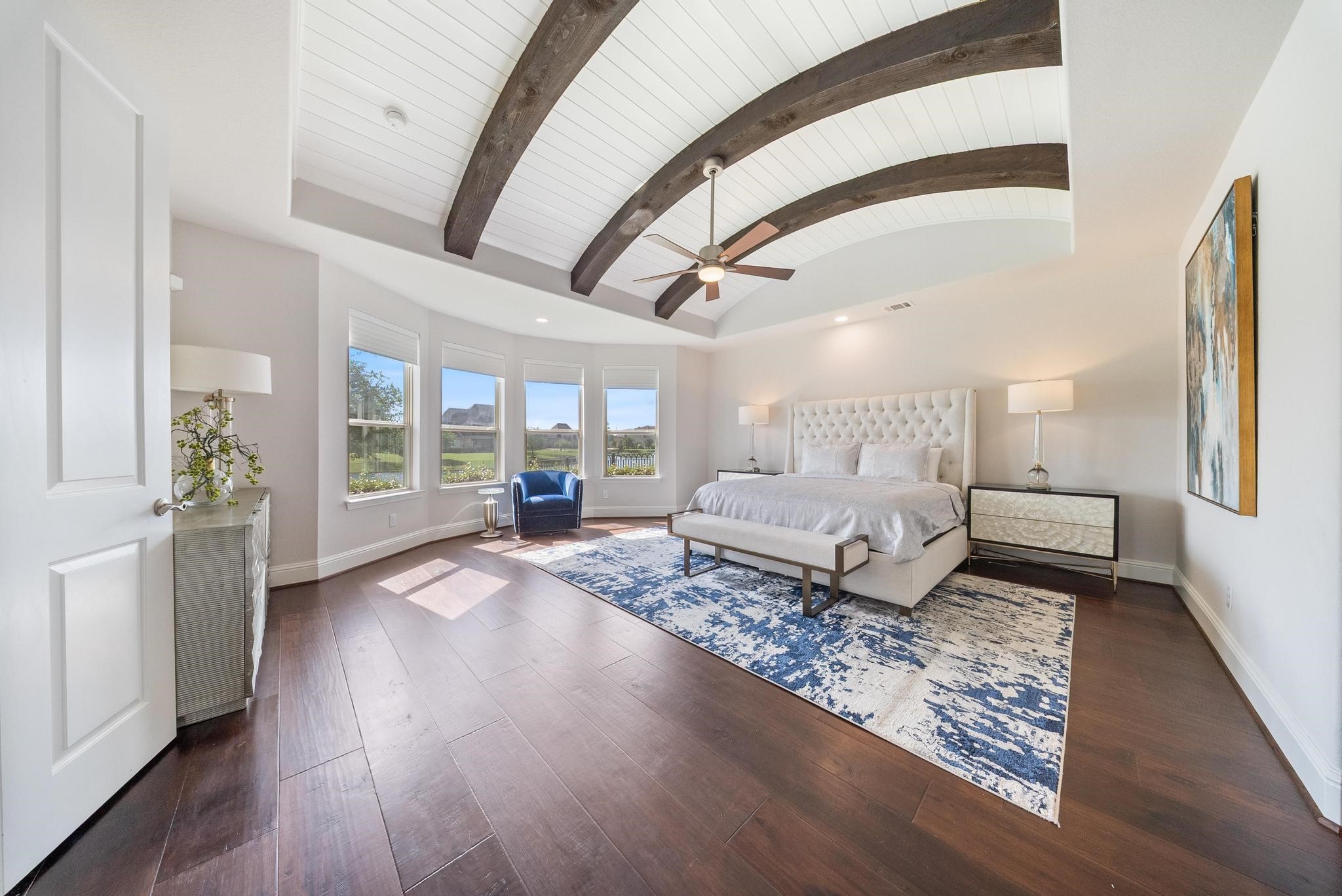 5403 Rouchel Brook Lane Sugar Land, TX 77479 - Photo 14 of 42 Luxurious primary suite with vaulted ceilings, exposed beams, and an extended bay-window offering serene lake-views.