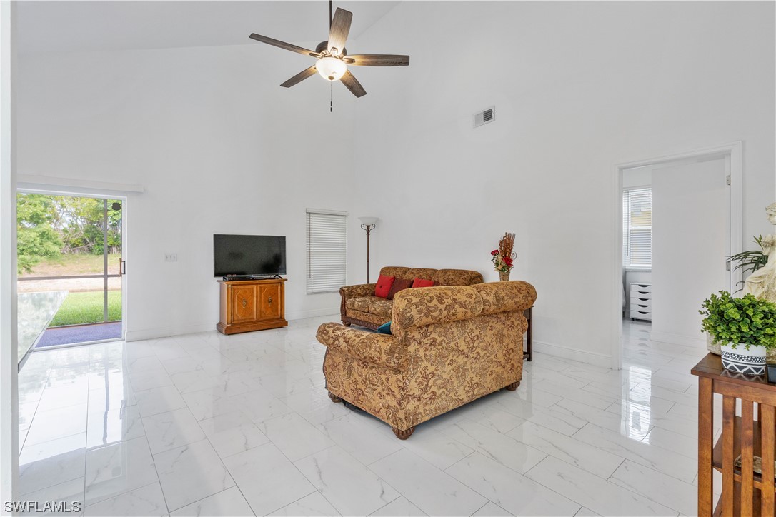 21660 Windham Run Estero, FL 33928 - Photo 12 of 32 a living room with furniture and a flat screen tv