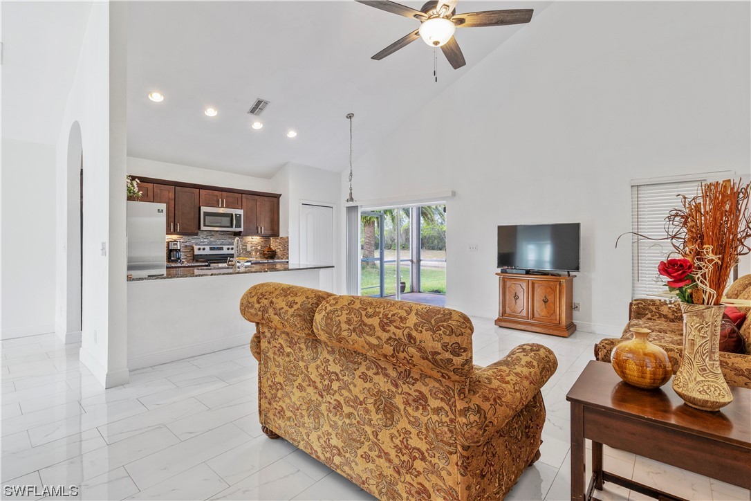 21660 Windham Run Estero, FL 33928 - Photo 13 of 32 a living room with furniture and a flat screen tv