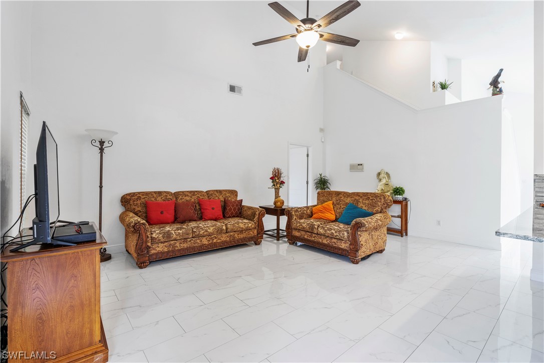 21660 Windham Run Estero, FL 33928 - Photo 14 of 32 a living room with furniture and a flat screen tv
