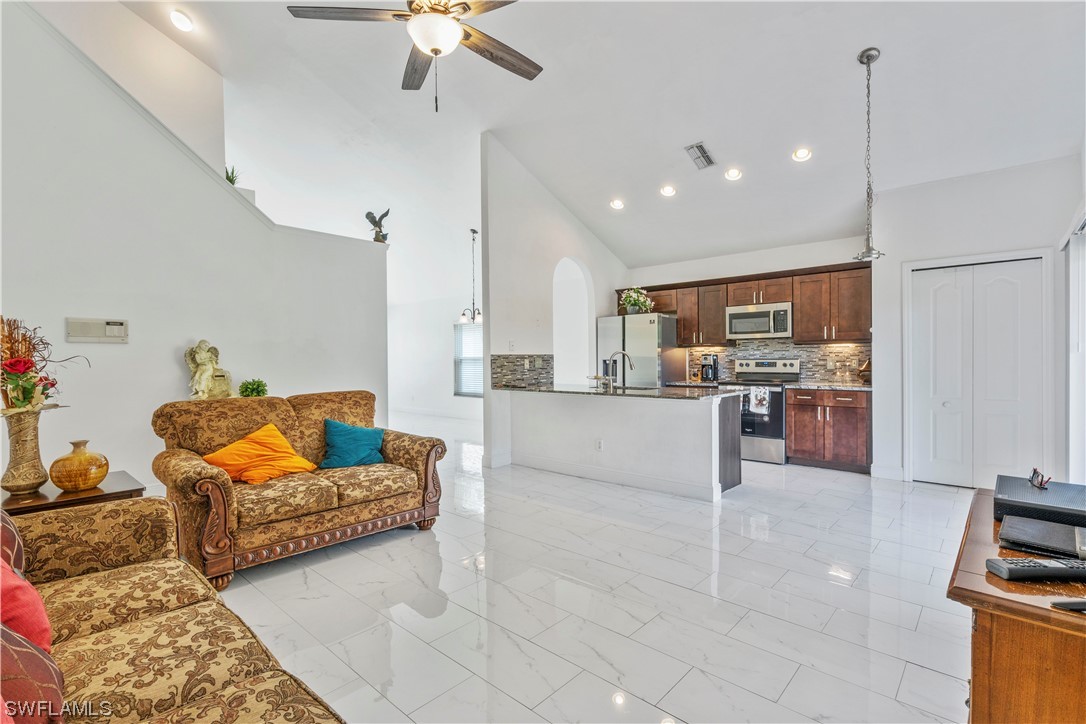 21660 Windham Run Estero, FL 33928 - Photo 18 of 32 a living room with furniture and kitchen view