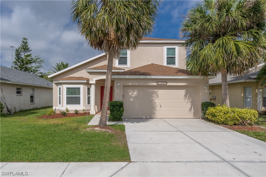 21660 Windham Run Estero, FL 33928 - Photo 2 of 32 a front view of house with yard and green space