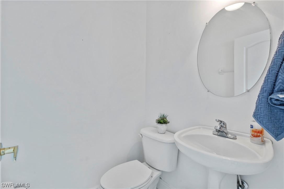 21660 Windham Run Estero, FL 33928 - Photo 22 of 32 a bathroom with a sink and toilet