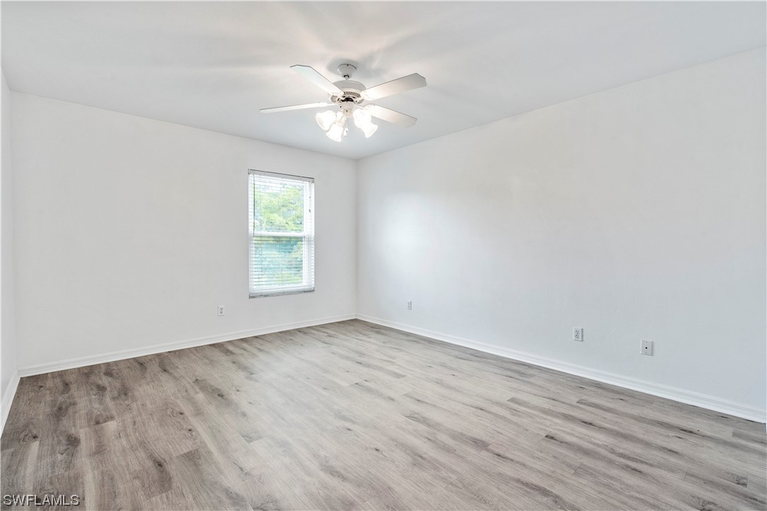 21660 Windham Run Estero, FL 33928 - Photo 24 of 32 a view of an empty room with wooden floor and a window