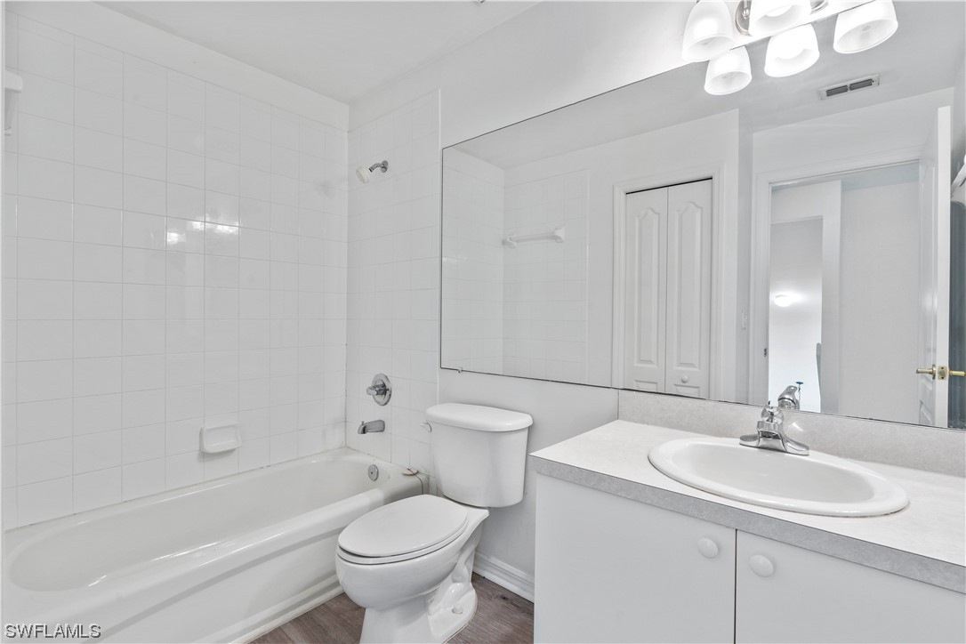 21660 Windham Run Estero, FL 33928 - Photo 27 of 32 a bathroom with a toilet a sink a mirror a bathtub and vanity