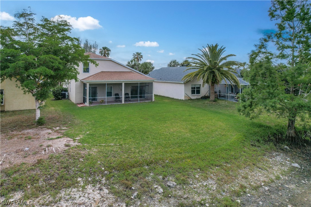 21660 Windham Run Estero, FL 33928 - Photo 28 of 32 a front view of a house with yard and green space