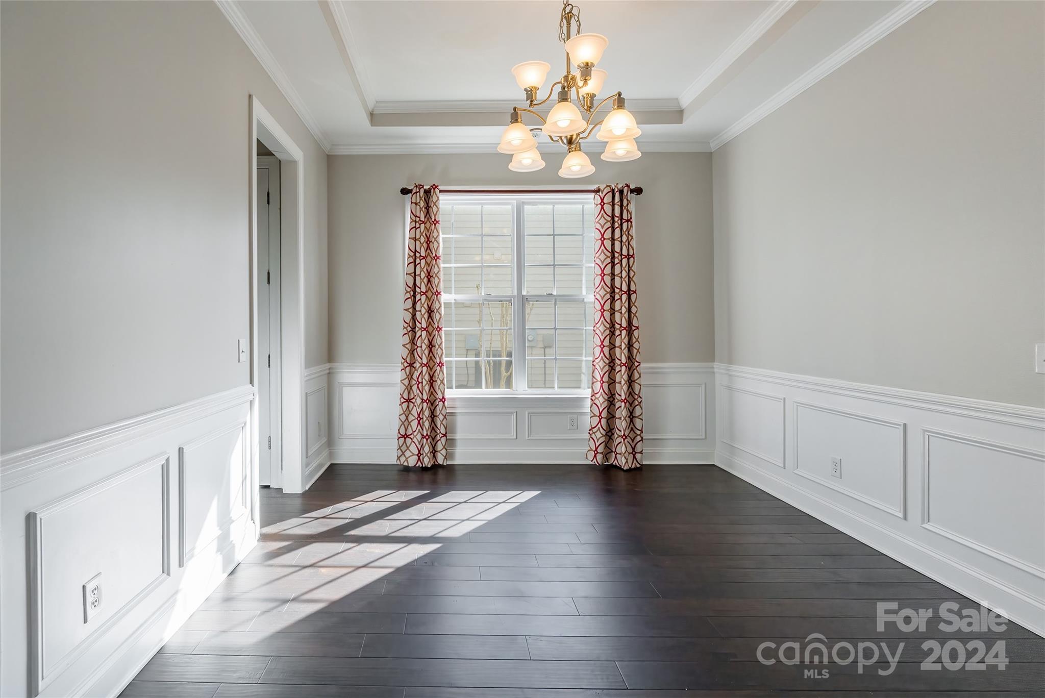 1123 Gold Rush Court Fort Mill, SC 29708 - Photo 8 of 40 an empty room with wooden floor chandelier and windows