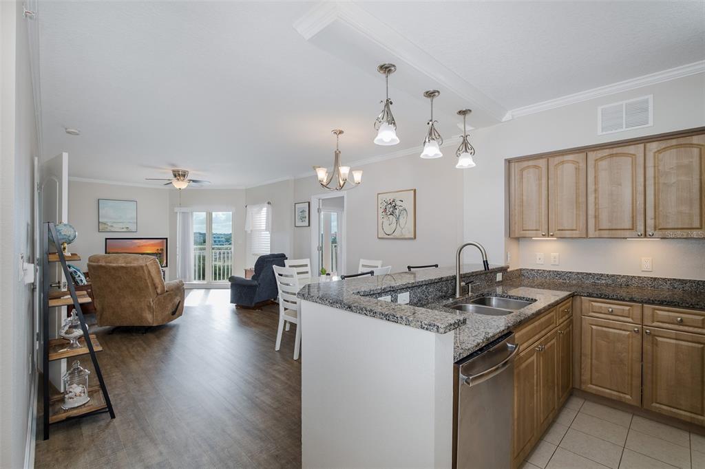 4516 Seagull Drive, Unit 411 New Port Richey, FL 34652 - Photo 13 of 47 a kitchen with a sink stove and cabinets