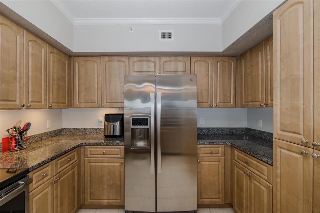 4516 Seagull Drive, Unit 411 New Port Richey, FL 34652 - Photo 15 of 47 a kitchen with a refrigerator sink and cabinets