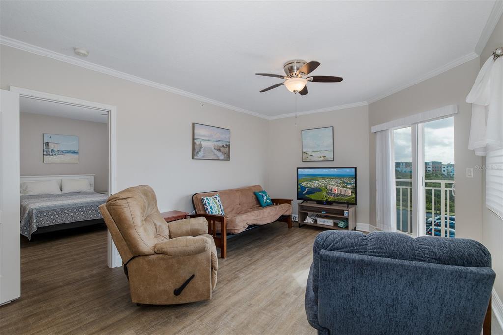 4516 Seagull Drive, Unit 411 New Port Richey, FL 34652 - Photo 18 of 47 a living room with furniture a flat screen tv and a window