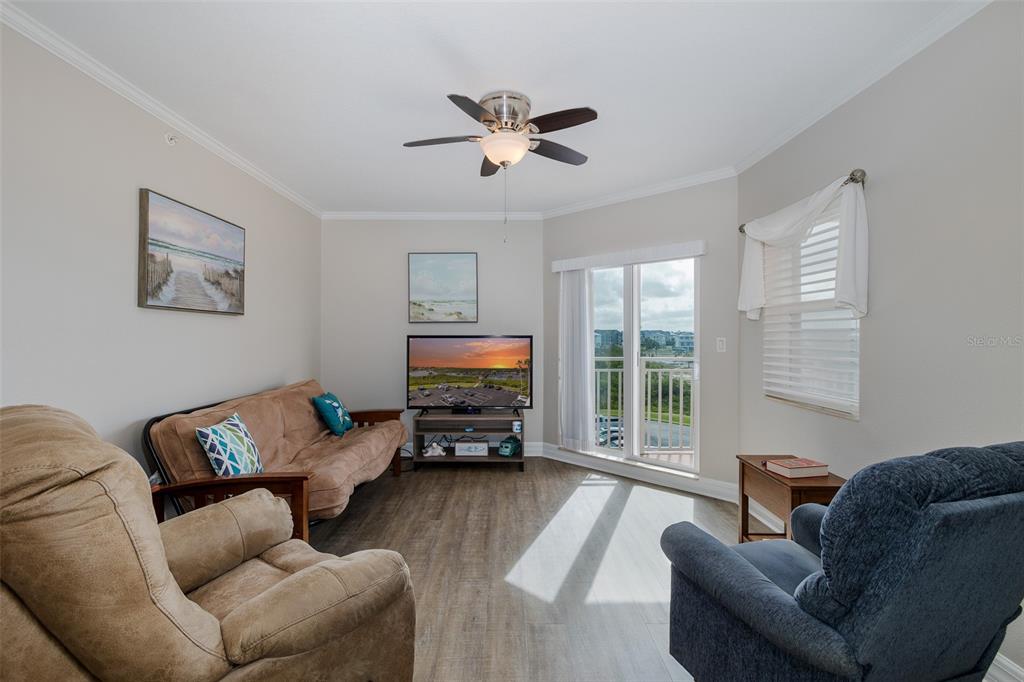 4516 Seagull Drive, Unit 411 New Port Richey, FL 34652 - Photo 19 of 47 a living room with furniture and a flat screen tv