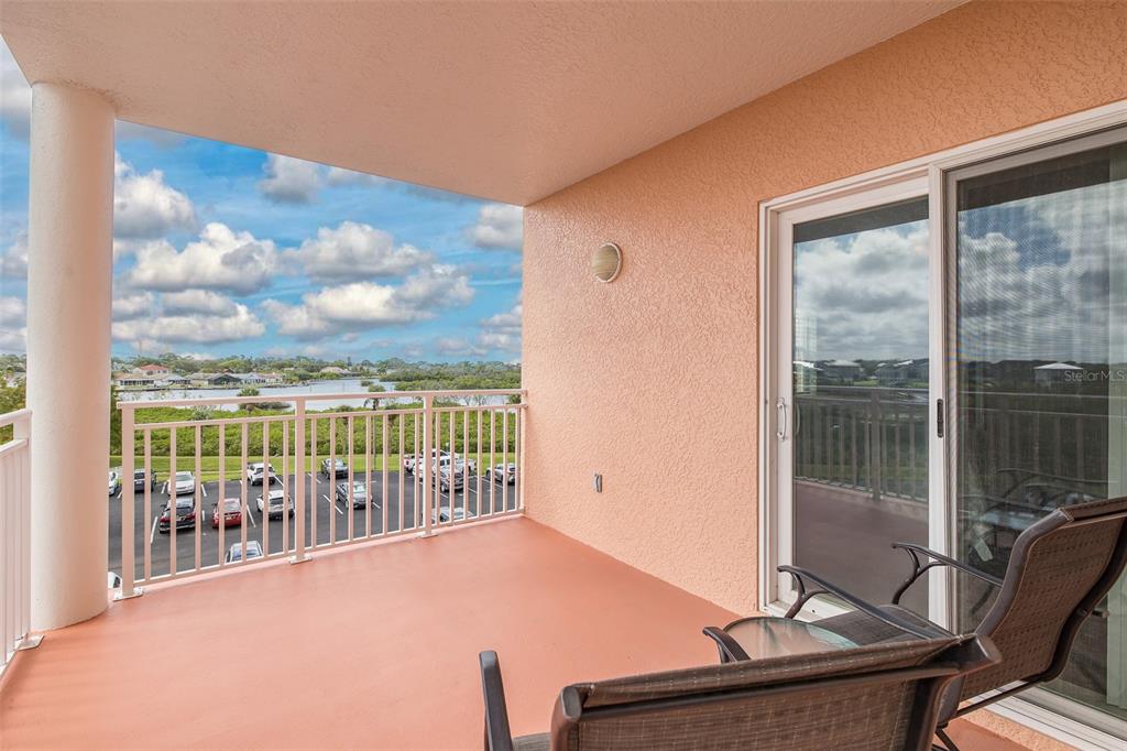 4516 Seagull Drive, Unit 411 New Port Richey, FL 34652 - Photo 20 of 47 a view of a balcony with chair and table