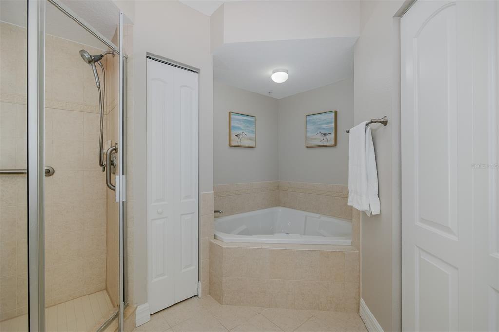 4516 Seagull Drive, Unit 411 New Port Richey, FL 34652 - Photo 23 of 47 a white bath tub sitting next to a bathroom