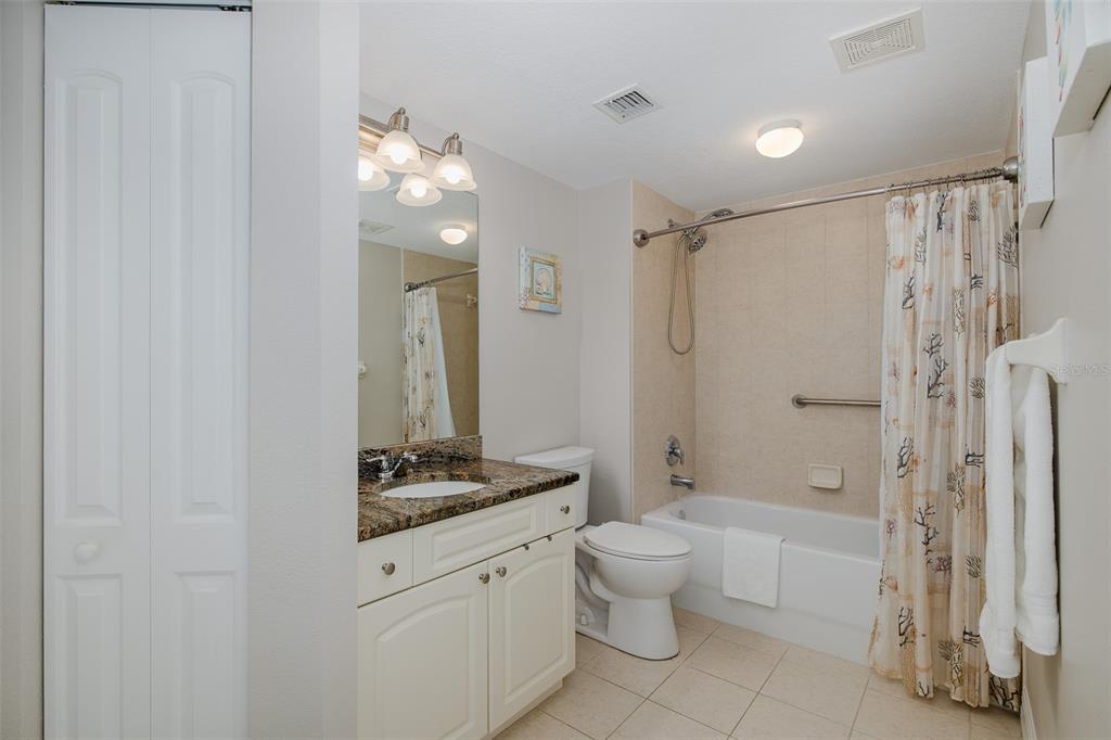 4516 Seagull Drive, Unit 411 New Port Richey, FL 34652 - Photo 27 of 47 a bathroom with a double vanity sink toilet mirror and shower