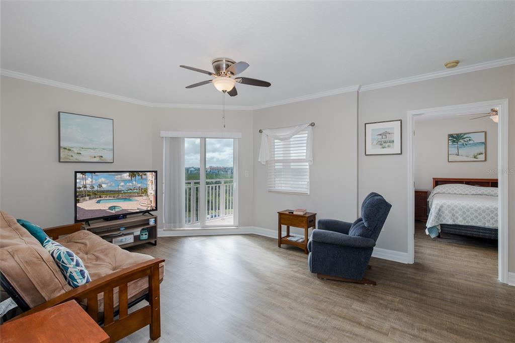 4516 Seagull Drive, Unit 411 New Port Richey, FL 34652 - Photo 3 of 47 a living room with furniture and a flat screen tv